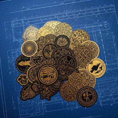 Industrial-style vinyl stickers with gold and black designs on a blueprint